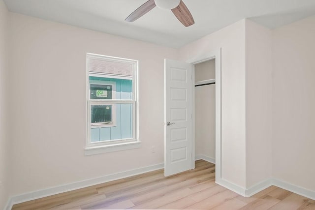 unfurnished bedroom with ceiling fan and light wood-type flooring