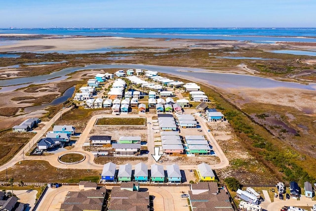 drone / aerial view with a water view and a beach view