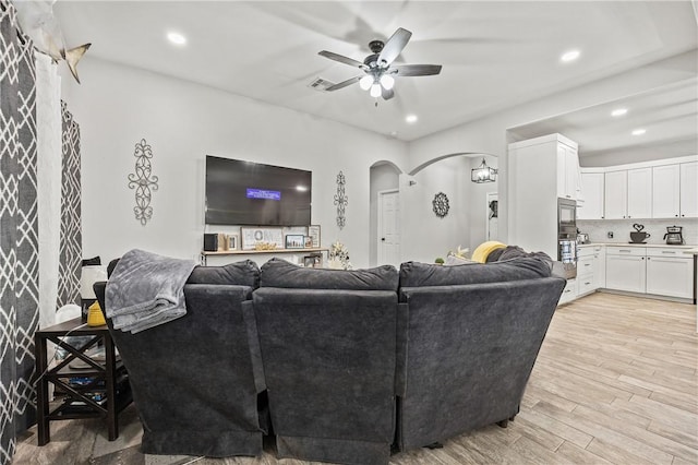 living room featuring light wood-type flooring and ceiling fan