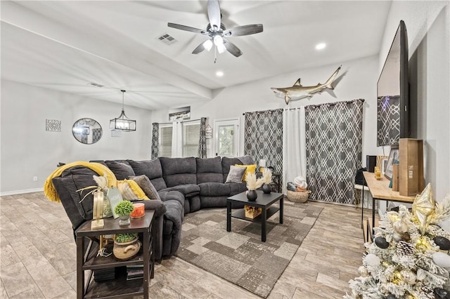 living room featuring ceiling fan with notable chandelier