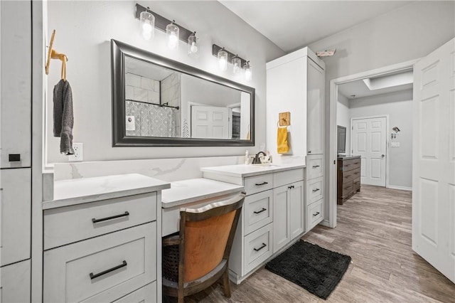 bathroom featuring vanity, wood-type flooring, and a shower with shower curtain