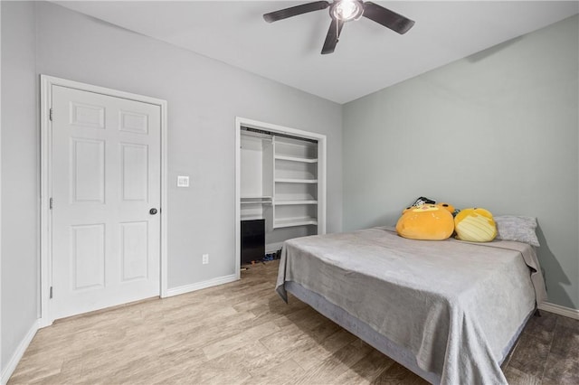 bedroom with ceiling fan, a closet, and light hardwood / wood-style flooring