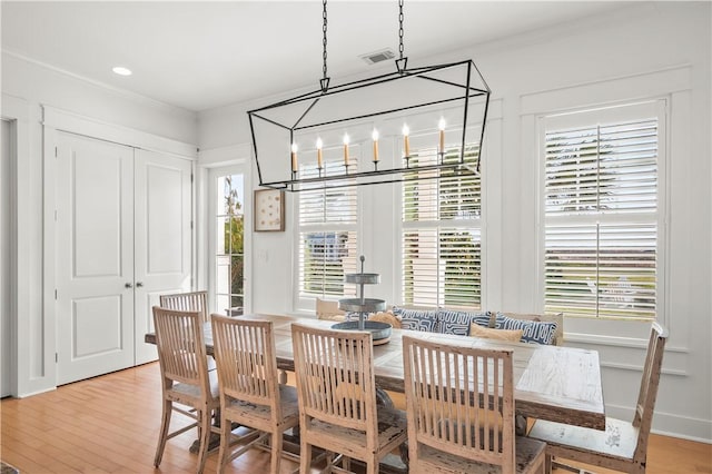 dining room with crown molding and wood-type flooring