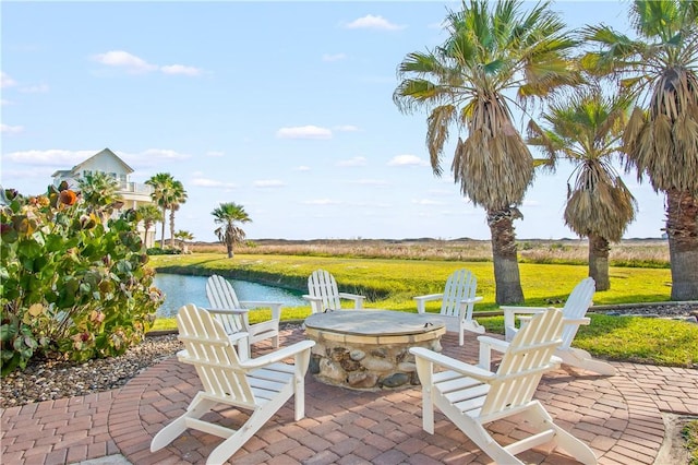 view of patio / terrace featuring a water view and an outdoor fire pit