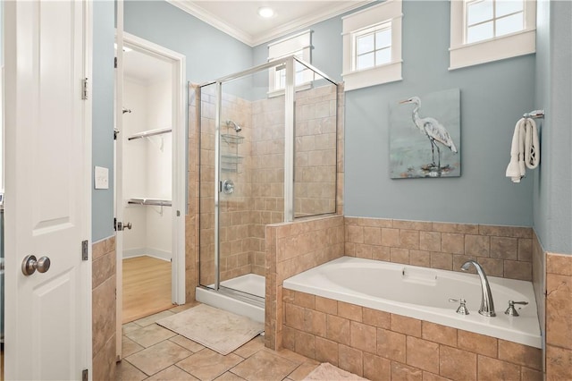 bathroom featuring tile patterned floors, ornamental molding, and separate shower and tub