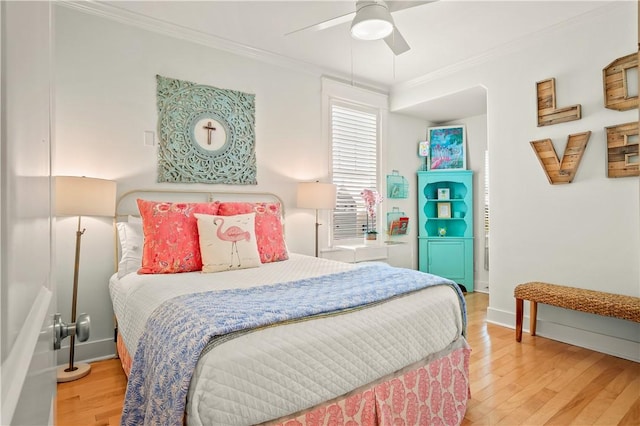 bedroom with crown molding, wood-type flooring, and ceiling fan