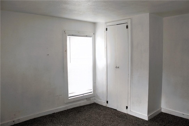 1110 Elgin St, Corpus Christi, TX 78405 - unfurnished bedroom featuring dark carpet and baseboards