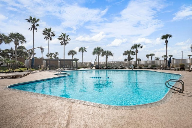 community pool featuring a patio and fence