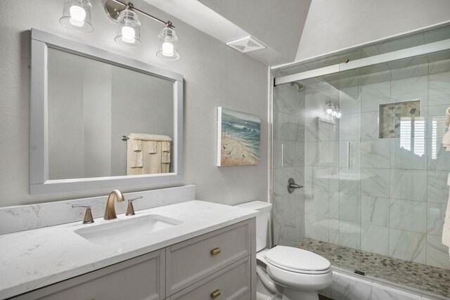 bathroom with visible vents, toilet, and a stall shower