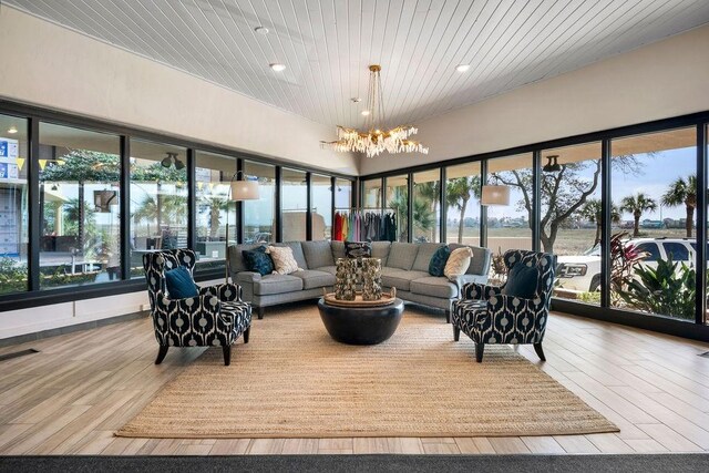 sunroom / solarium featuring visible vents, wood ceiling, and an inviting chandelier