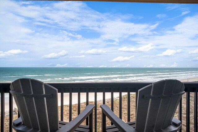 balcony featuring a beach view and a water view