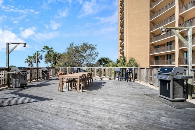 deck featuring outdoor dining area and grilling area