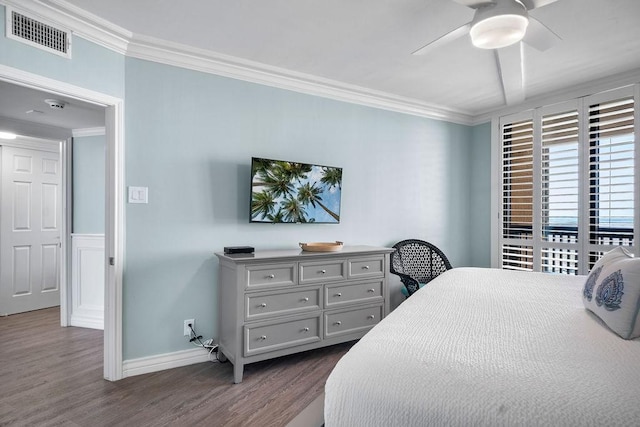 bedroom featuring visible vents, ornamental molding, baseboards, ceiling fan, and dark wood-style flooring