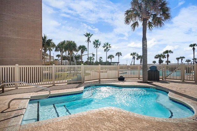 view of pool featuring a swimming pool and fence