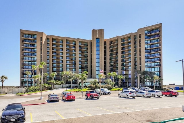 view of building exterior with uncovered parking