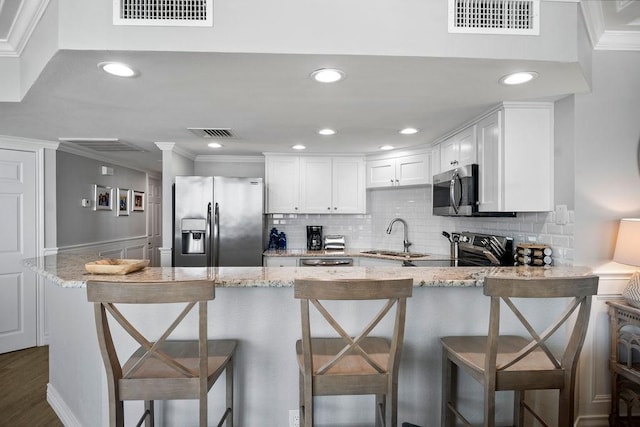 kitchen featuring visible vents, appliances with stainless steel finishes, and a sink