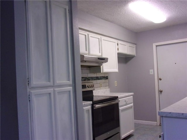 kitchen featuring electric stove, decorative backsplash, white cabinets, and a textured ceiling