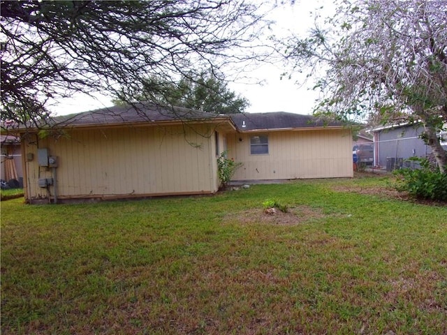 rear view of property with a yard