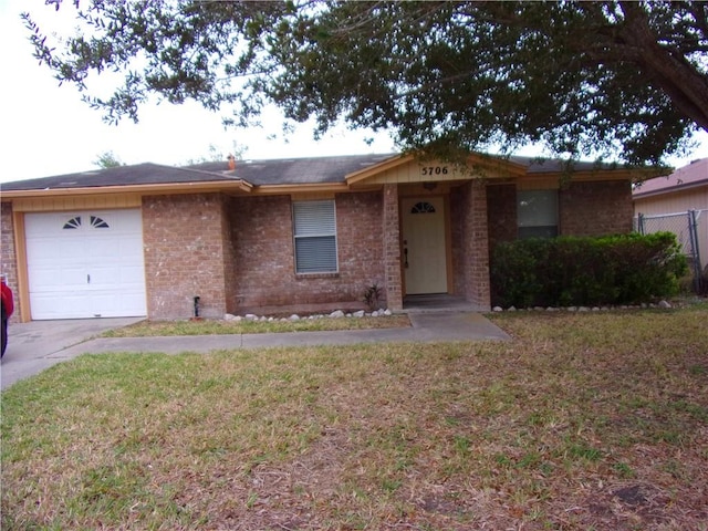 ranch-style home featuring a front lawn and a garage