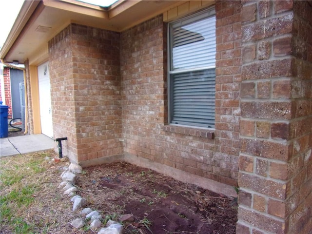 view of side of property with brick siding