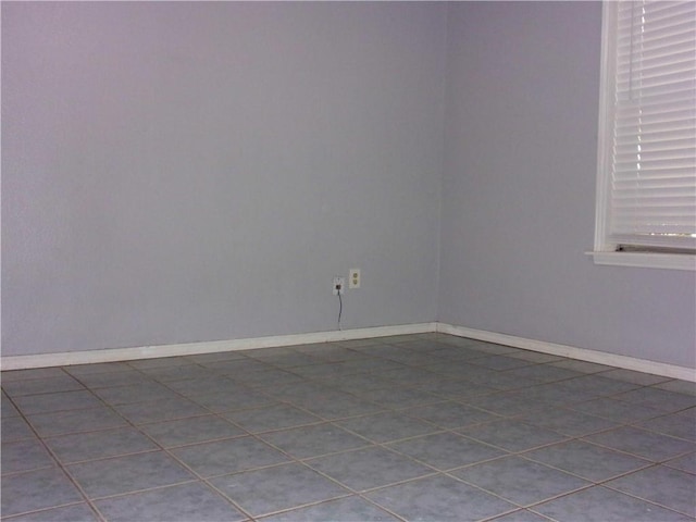 spare room with baseboards