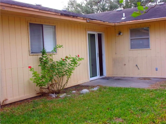 doorway to property featuring a yard and a patio