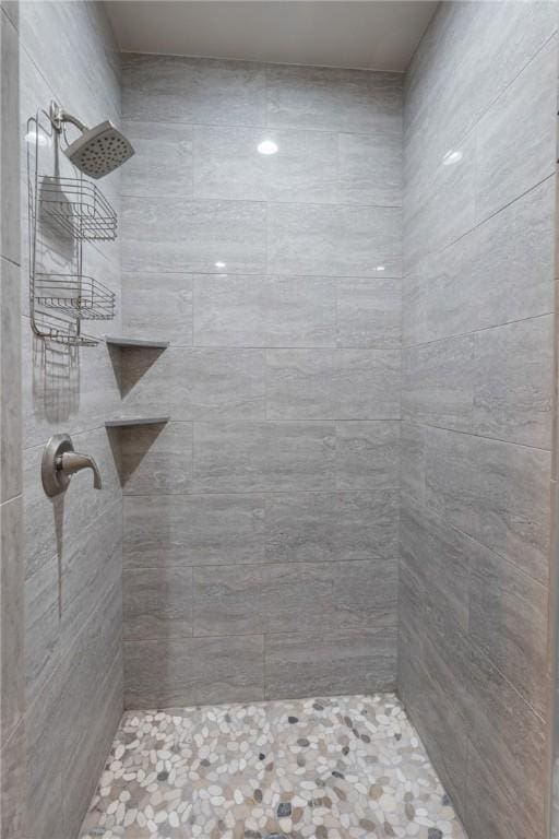 bathroom with a tile shower