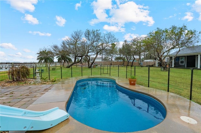 view of pool with a yard and a patio