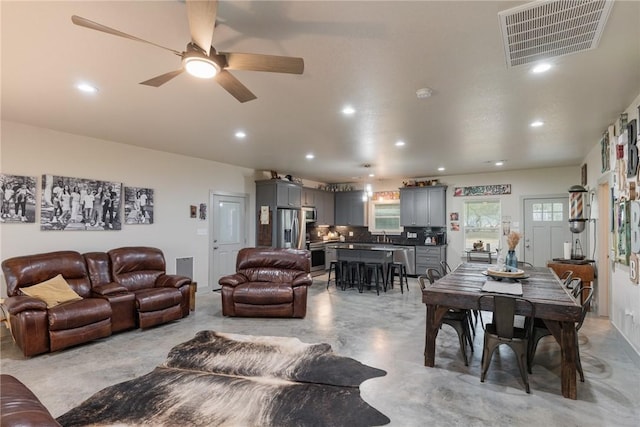 living room featuring ceiling fan and sink