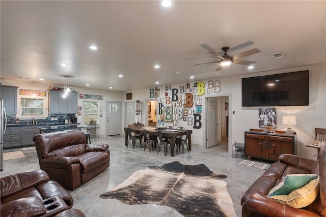 living room with sink and ceiling fan