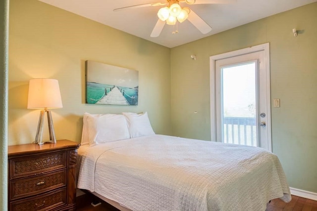 bedroom with dark hardwood / wood-style flooring and ceiling fan