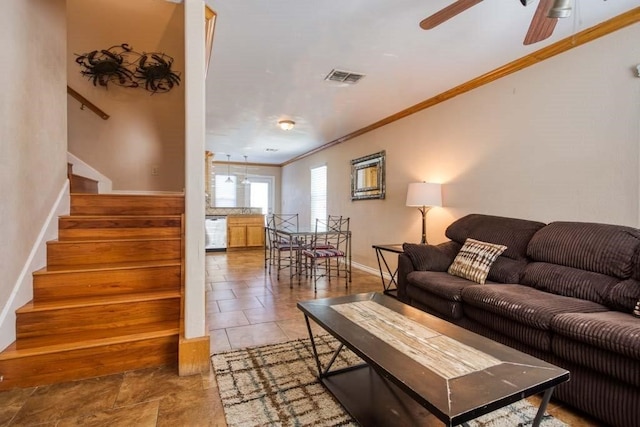 living room featuring ceiling fan and crown molding