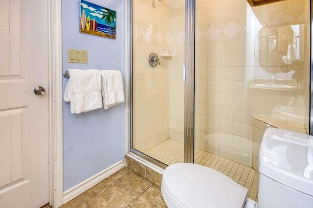 bathroom with toilet, an enclosed shower, and tile patterned floors