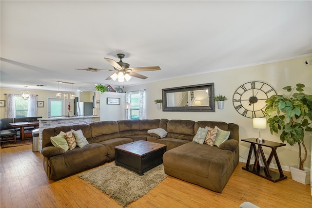 living room with ceiling fan, light hardwood / wood-style flooring, and crown molding