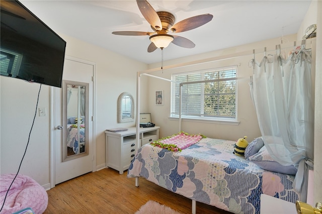 bedroom with ceiling fan and light wood-type flooring