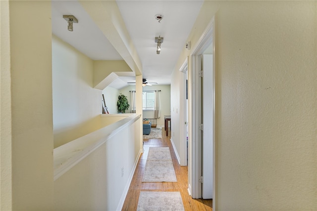 corridor with light hardwood / wood-style flooring