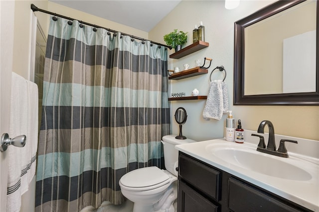 bathroom with vanity, curtained shower, and toilet