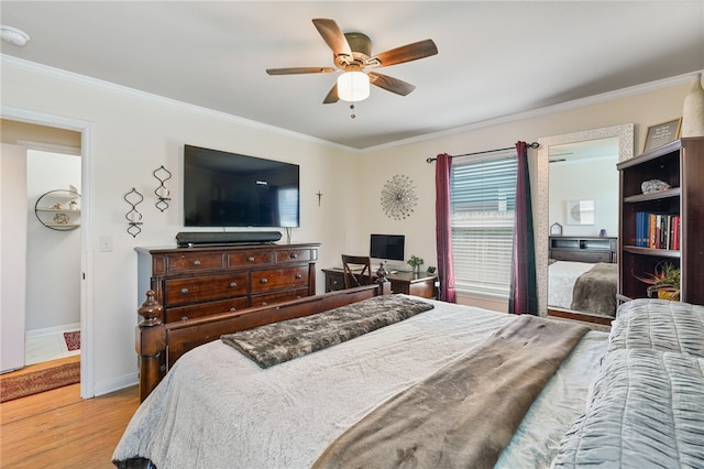 bedroom with ceiling fan, light wood-type flooring, and crown molding