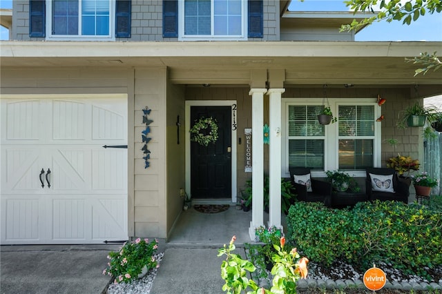 property entrance featuring a porch and a garage