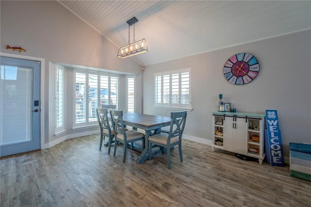 dining space featuring hardwood / wood-style flooring and high vaulted ceiling