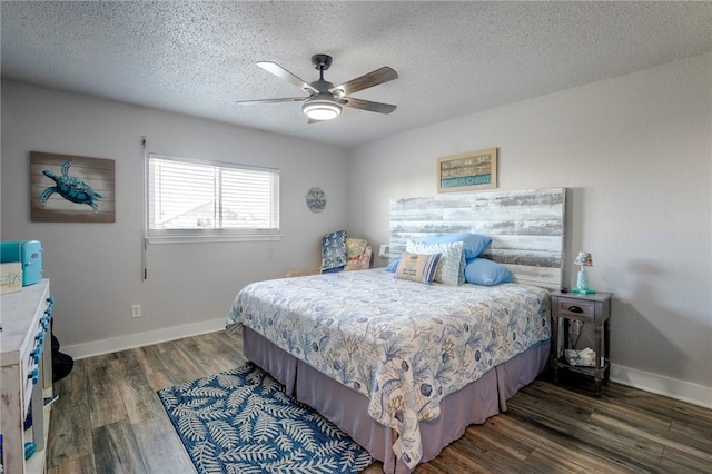 bedroom featuring ceiling fan, dark hardwood / wood-style floors, and a textured ceiling