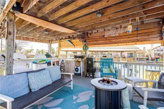 view of patio with an outdoor living space with a fire pit