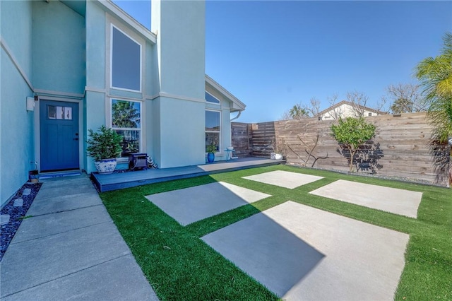 view of yard featuring a patio area and a fenced backyard