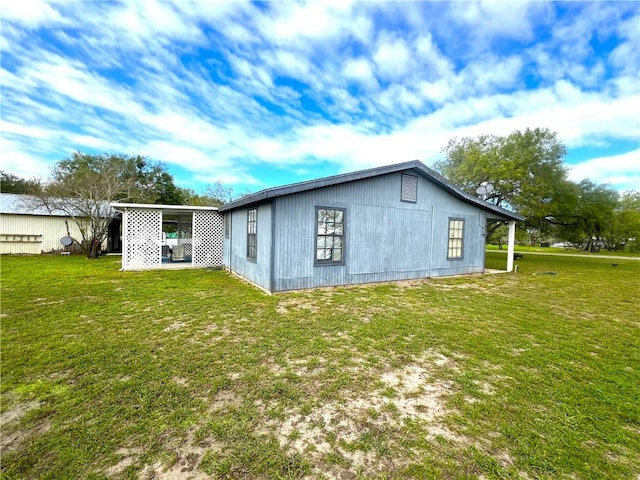 rear view of property featuring a yard