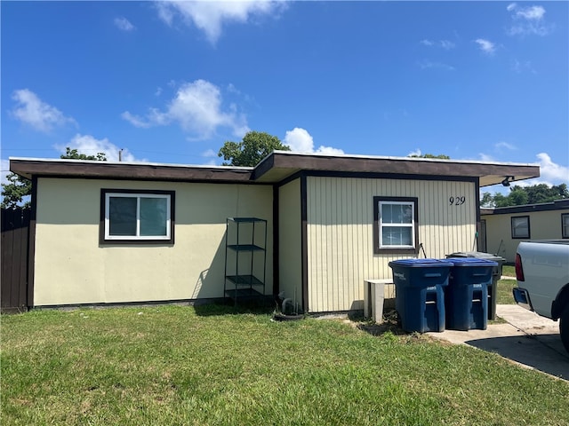 view of side of home with a lawn