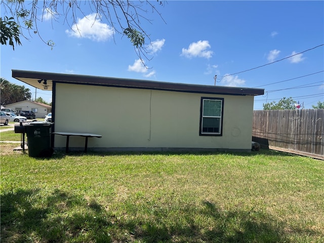 view of side of home with a lawn