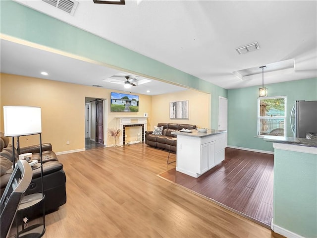 1205 Brentwood Dr, Corpus Christi, TX 78404 - living area featuring ceiling fan, a fireplace, wood finished floors, and recessed lighting