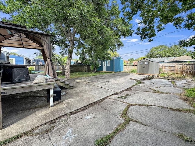 1205 Brentwood Dr, Corpus Christi, TX 78404 - fenced backyard featuring a storage unit and a patio