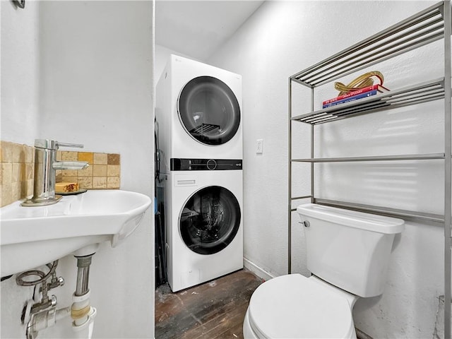 1205 Brentwood Dr, Corpus Christi, TX 78404 - bathroom featuring estacked washer and dryer, wood finished floors, and tasteful backsplash
