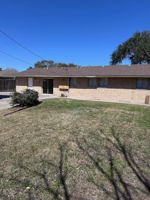 4633 Wilma Dr, Corpus Christi, TX 78412 - back of property featuring brick siding and a yard
